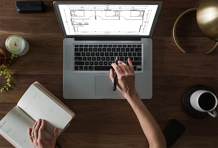A worker is designing layout of expandable container house.