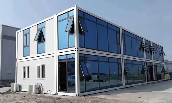 A two-story building is made of flat pack container houses.