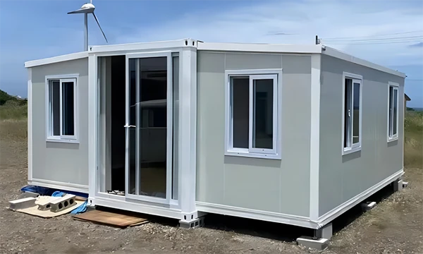 A gray color 20ft expandable container house is placed on the river bank.