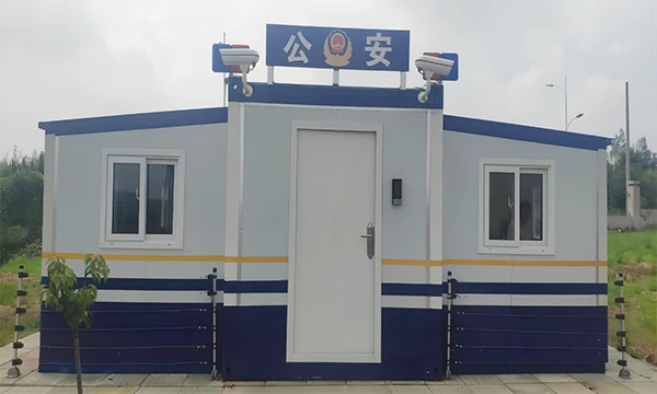 A 20' expandable container house is placed on the ground and is decorated as the police office.